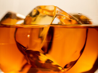 Whisky on the rocks, glass filled with ice cubes
