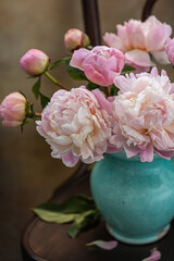Obraz premium Bouquet of pink peonies in an old blue jug