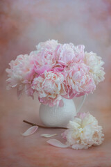 Bouquet of peonies in a vase on a gentle retro background