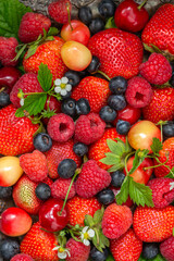 Many different ripe berries strawberries, raspberries, blueberries, sweet cherries as background texture. Flat lay, top view