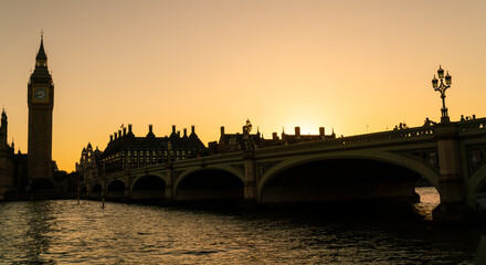 Fototapeta na wymiar People walking across Westminster Bridge, Big Ben at Sunset in London, England