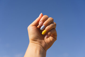Yellow and blue manicure. Girl with manicure of ukrainian flag colors. Flag of Ukraine, freedom...