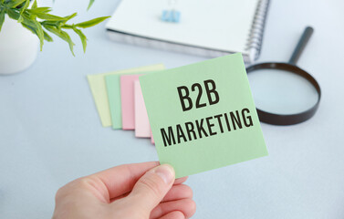B2B Marketing text on white paper in hand.