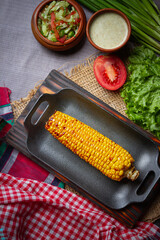 Barbecue chicken wings close up on wooden tray, shot with selective focus