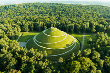 Aerial view of the famous Pilsudski's Mound in a sunny summer day, an artificial mound located in the western part of Krakow, on the Sowiniec Heights. - obrazy, fototapety, plakaty