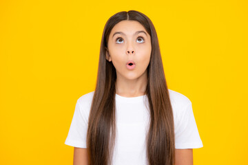 Little kid girl 12,13, 14 years old on isolated background. Children studio portrait. Emotional kids face. Amazed surprised emotions of young teenager girl.