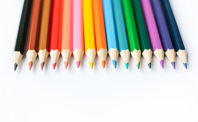 A set of colored pencils isolated on a white background in banner format. Place for text