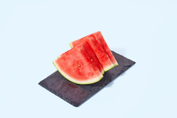 Fresh sliced watermelon on blue background