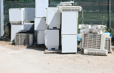 recycler landfill for the separate collection of bulky broken appliances used with old white refrigerators and air conditioning systems - obrazy, fototapety, plakaty