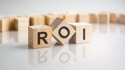 ROI - Return On Investment shot form on wooden block