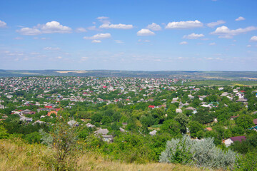 Fototapeta na wymiar Moldova, Trusheni. Suburb of Chisinau. View of a beautifully located village in the hills on a bright sunny summer day.