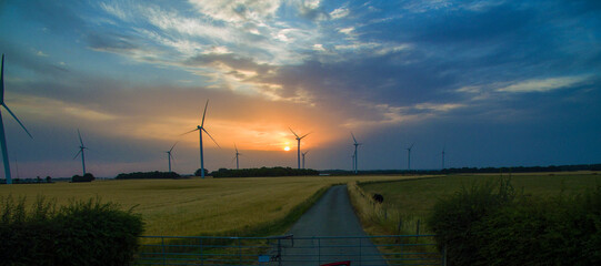 aerial view of wind turbines at sunset, wind farm producing green clean renewable energy