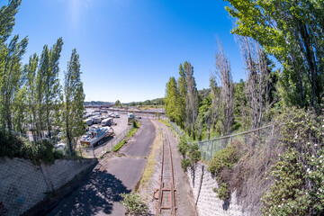 Railroad tracks below under blue summer sky
