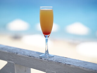 Delicious fruit cocktail with tequila on tropical beach. Ocean on background.