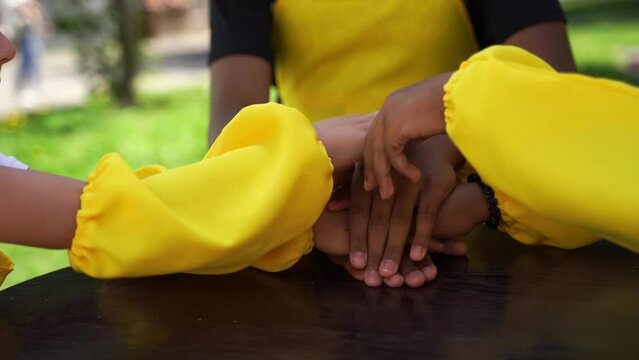 Multiracial children hands together forming pile close-up. Friendship of multinational kids. Childhood.