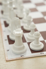 Chessboard and white figure rook close up. Blur and selective focus.