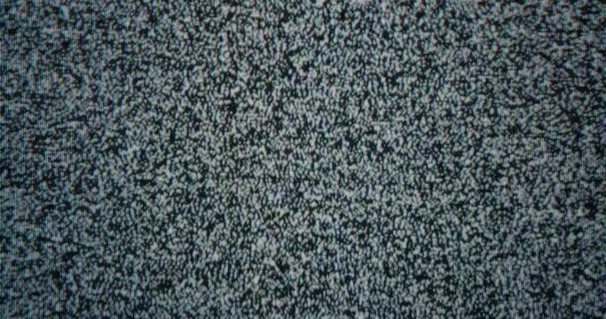 Close-up of  old analog TV screen broadcasting white noise. Concept of media zombification and utility bills. Cable television was turned off for non-payment.