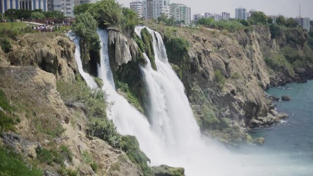 Duden waterfall in the Duden park on the Mediterranean coast in Antalya, Turkey. View of seascape, azure sea and steep rock on a sunny day.