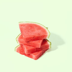 Cut watermelon on green pastel background