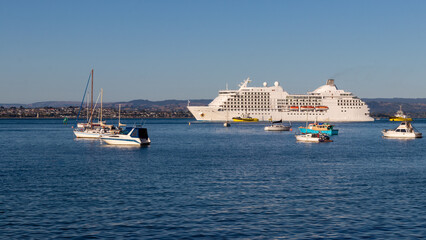 Fototapeta na wymiar Cruise ship with pilot boats is coming to harbour