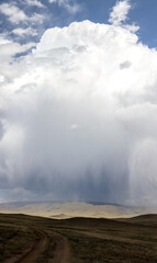 gigantic rain cloud in the hilly landscape