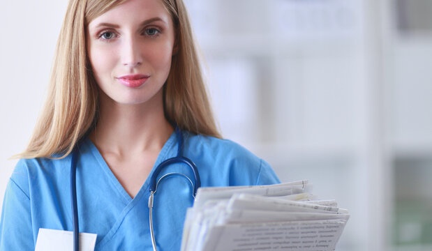 Doctor woman is standing in the near window