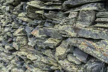 stone wall background from weathered slate stones