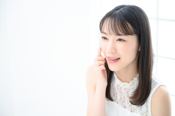 Fototapeta premium Young woman concerned about acne, copy space available on left