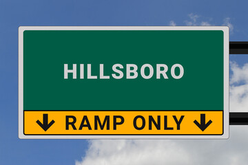 Hillsboro logo. Hillsboro lettering on a road sign. Signpost at entrance to Hillsboro, USA. Green pointer in American style. Road sign in the United States of America. Sky in background