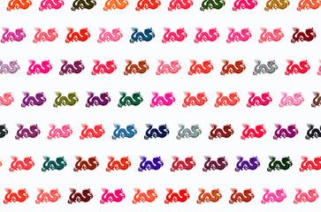 Row of colored dragon polka on white background