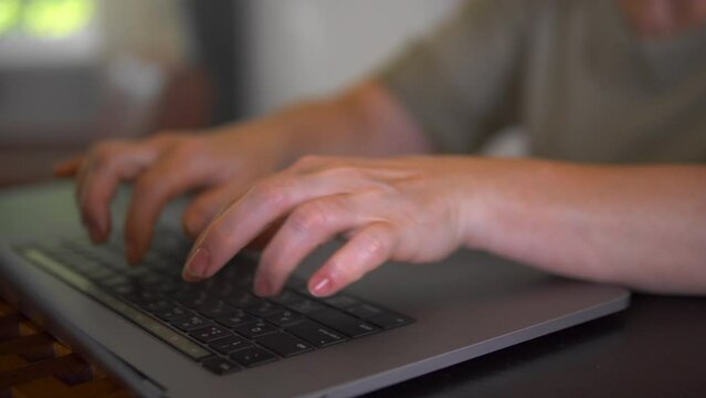 A programmer is writing program code on the laptop.