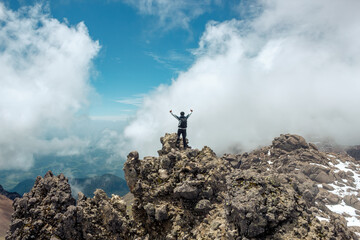 Young man with backpack standing on top of mountain in volcano iztaccihuatl © Nailotl