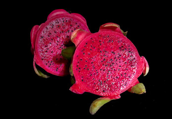 Dragon fruit set isolated on a black background as a package design element. Healthy food Photography natural ripe colours red pink black. Studio high-quality photography 