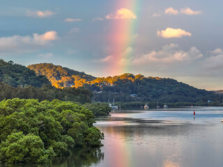 Rainy day sunset with rainbow at the waterfront