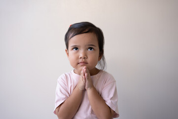 Asian little girl praying hopeful eyes, hope and peace concept. Asia kid in hopeful reaction.