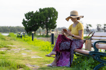Woman look at mobile phone at park