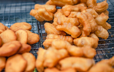 Flour is fried in a pan with hot oil as a fried dough stick to eat with coffee or dipped in sweetened condensed milk. It is sold in Thai roadside markets.