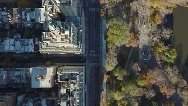 Aerial birds eye overhead top down view of buildings and street along Central park. Two towers of historical San Remo building. Manhattan, New York City, USA