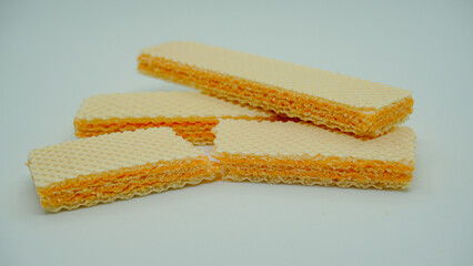 Tasty wafer sticks on white background, flat lay. Sweet food
