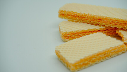 Tasty wafer sticks on white background, flat lay. Sweet food
