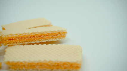 Tasty wafer sticks on white background, flat lay. Sweet food
