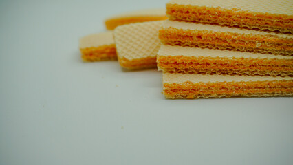 Tasty wafer sticks on white background, flat lay. Sweet food

