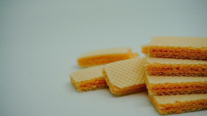 Tasty wafer sticks on white background, flat lay. Sweet food
