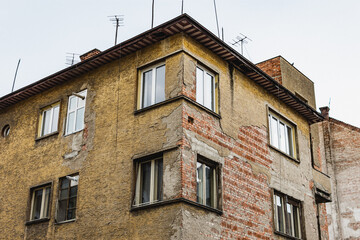 Old degraded and abandoned building in an European city with windows