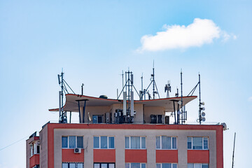 5G antennas on the roof of an apartment building fir a better signal coverage in the urban area