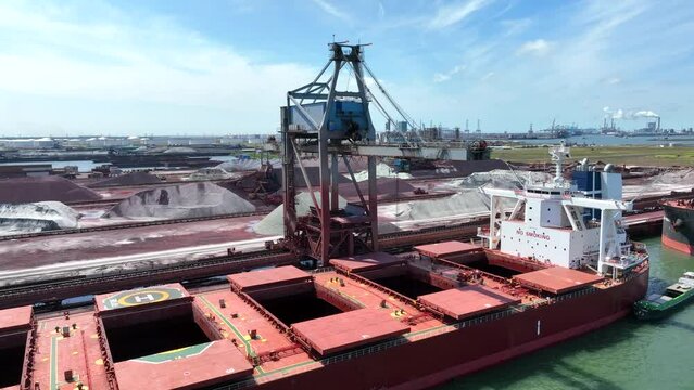 Cranes Unloading a Bulk Carrier Ship at Port
