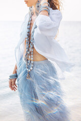 Fototapeta premium beautiful young stylish woman walking on the beach close up