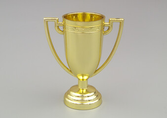 Gold trophy cup on gray background 