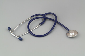 Stethoscope on gray background close-up. Symbol of medicine and medical exam.