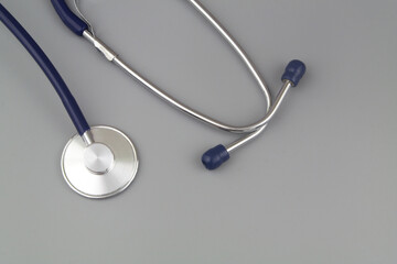 Stethoscope on gray background with room for text. Medicine and heals care concept.